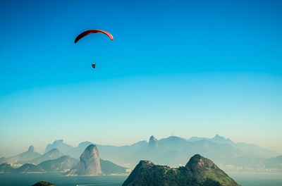 空白照片的图片-一个人白天在火山湖上空跳伞的全景照片